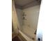 Bathroom tub and shower combination with white tile surround and neutral colors at 2021 Oliver Pl, Winter Haven, FL 33881