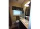 Bathroom vanity with light countertop, and a framed mirror, creating a functional space at 2021 Oliver Pl, Winter Haven, FL 33881