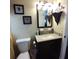 Bathroom vanity with granite countertop and decorative mirror, complemented by neutral decor at 2021 Oliver Pl, Winter Haven, FL 33881