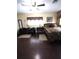 Comfortable bedroom showcasing wood-look flooring and ample natural light from the windows at 2021 Oliver Pl, Winter Haven, FL 33881