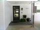 Close up of front door entry with address plaque, decorations, and door bell at 2021 Oliver Pl, Winter Haven, FL 33881