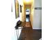 Inviting hallway with dark floors, console table, and view of living area at 2021 Oliver Pl, Winter Haven, FL 33881