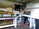 Organized shed interior with shelves, work tables, cabinets, and a mini fridge for optimal storage and functionality at 2021 Oliver Pl, Winter Haven, FL 33881
