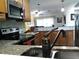 Lovely kitchen view, includes stainless steel appliances, stylish granite counters and warm, wood cabinets at 2021 Oliver Pl, Winter Haven, FL 33881