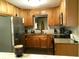 Bright kitchen features wood cabinetry, stainless appliances and light countertops at 2021 Oliver Pl, Winter Haven, FL 33881