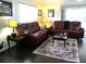 Comfortable living room featuring two leather sofas and large area rug at 2021 Oliver Pl, Winter Haven, FL 33881