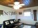 Comfortable living room has wood ceiling, rustic decor and comfortable seating at 2021 Oliver Pl, Winter Haven, FL 33881