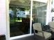 Enclosed patio with comfortable seating, sliding glass doors and views of the landscaped yard at 2021 Oliver Pl, Winter Haven, FL 33881