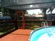 Screened deck with above ground pool and attached ladder at 2021 Oliver Pl, Winter Haven, FL 33881