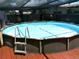 Spacious above-ground pool, perfect for a refreshing swim, surrounded by a wooden deck at 2021 Oliver Pl, Winter Haven, FL 33881