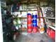 View of interior of shed containing storage items and lawn care supplies at 2021 Oliver Pl, Winter Haven, FL 33881