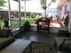Relaxing sunroom with screened windows, opening to a lush, landscaped backyard and an inviting outdoor retreat at 2021 Oliver Pl, Winter Haven, FL 33881