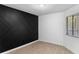 Minimalist bedroom featuring a modern accent wall and natural light streaming through the window at 2037 San Marcos Se Dr # 443, Winter Haven, FL 33880