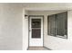 Close-up of the unit's front door, featuring a screen door, modern hardware, and a Ring security system at 2037 San Marcos Se Dr # 443, Winter Haven, FL 33880
