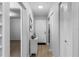 Clean hallway with hardwood floors, closet space, and a white front door with an adjacent decorative table at 2037 San Marcos Se Dr # 443, Winter Haven, FL 33880