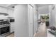 Hallway view with closet and kitchen leading into dining and living area with natural light and a neutral color palette at 2037 San Marcos Se Dr # 443, Winter Haven, FL 33880