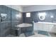 Modern bathroom featuring a glass-enclosed shower, soaking tub, and white vanity with double sinks at 209 Andros Ave # 15301, Davenport, FL 33897