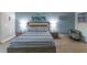 Stylish bedroom with striped bedspread and serene decor at 209 Andros Ave # 15301, Davenport, FL 33897