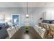 Chic dining area with long table and living room view at 209 Andros Ave # 15301, Davenport, FL 33897