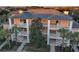 Three-story condo with white railings and palm trees at 209 Andros Ave # 15301, Davenport, FL 33897