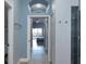 Hallway view to bedroom with balcony in neutral tones at 209 Andros Ave # 15301, Davenport, FL 33897