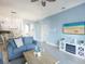 Comfortable living room with kitchen view and beach artwork at 209 Andros Ave # 15301, Davenport, FL 33897