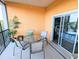 Relaxing screened patio with table and chairs, and a view into the connected bedroom through sliding glass doors at 209 Andros Ave # 15301, Davenport, FL 33897