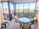 Enjoy outdoor dining on this screened patio with a table and chairs overlooking a serene view at 209 Andros Ave # 15301, Davenport, FL 33897