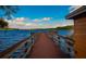 A wooden pier extends into the calm lake, offering scenic views and recreational opportunities at 209 Andros Ave # 15301, Davenport, FL 33897