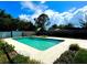 Refreshing in-ground pool surrounded by a concrete deck and lush landscaping in a private backyard at 2159 Greenway Dr, Winter Haven, FL 33881