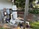 Pool equipment with filter, motor, electrical box and PVC plumbing near a wooden support post at 2159 Greenway Dr, Winter Haven, FL 33881
