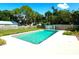 Sparkling backyard pool with an adjacent storage shed, bordered by a wooden fence and lush greenery at 2159 Greenway Dr, Winter Haven, FL 33881