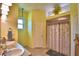 Bright bathroom with double sink vanity, tiled floors, and shower with curtain at 2252 Fox Run Rd, Lake Wales, FL 33898