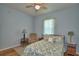 Cozy bedroom features a floral bedspread and comfortable furnishings under a ceiling fan at 2252 Fox Run Rd, Lake Wales, FL 33898