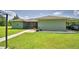View of home's exterior featuring a screened lanai and covered carport at 2252 Fox Run Rd, Lake Wales, FL 33898