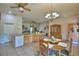Open kitchen and dining area with a chandelier, tile flooring, and wood cabinets at 2252 Fox Run Rd, Lake Wales, FL 33898