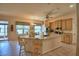 Spacious kitchen with island seating, tile floors, stainless steel appliances, and natural wood cabinets at 2252 Fox Run Rd, Lake Wales, FL 33898