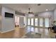 Open living room with tiled floors, access to a bathroom and lots of windows at 2252 Fox Run Rd, Lake Wales, FL 33898