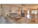 Comfortable living room with gray sofa, ceiling fan, and views into the kitchen and dining area at 2252 Fox Run Rd, Lake Wales, FL 33898