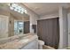 Bathroom featuring a vanity with granite countertop, mirror and shower at 2350 Paulette Dr, Haines City, FL 33844