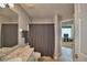 Bathroom with a gray shower curtain and tile floors, leading to other rooms at 2350 Paulette Dr, Haines City, FL 33844