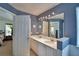 Bathroom with dual sinks, large mirrors, and modern lighting at 2350 Paulette Dr, Haines City, FL 33844