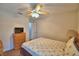 Relaxing bedroom features neutral colors, a ceiling fan, and a wood dresser at 2350 Paulette Dr, Haines City, FL 33844