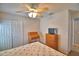 Comfortable bedroom features a ceiling fan, wardrobe, and wooden desk at 2350 Paulette Dr, Haines City, FL 33844