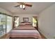 Bright bedroom with a ceiling fan, access to a pool view, and neutral colored walls at 2350 Paulette Dr, Haines City, FL 33844
