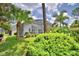 Backyard view of screened in lanai and surrounding landscaping at 2350 Paulette Dr, Haines City, FL 33844