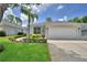 Charming single-story home with manicured lawn and well-maintained landscaping at 2350 Paulette Dr, Haines City, FL 33844