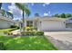 Well-maintained home with manicured lawn, complemented by a two-car garage and inviting landscaping at 2350 Paulette Dr, Haines City, FL 33844