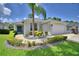 Charming single-story home with landscaped front yard, palm tree, and blue front door at 2350 Paulette Dr, Haines City, FL 33844