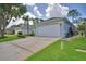 Two-car garage with wide driveway and well-manicured lawn at 2350 Paulette Dr, Haines City, FL 33844